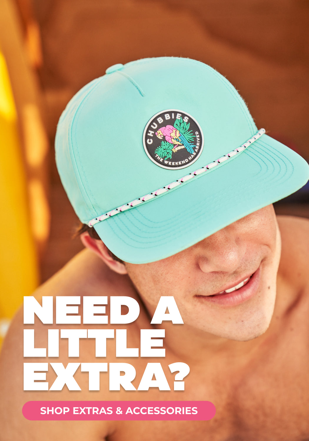 Man wearing a hat with text "NEED A LITTLE EXTRA? SHOP EXTRAS AND ACCESSORIES" 